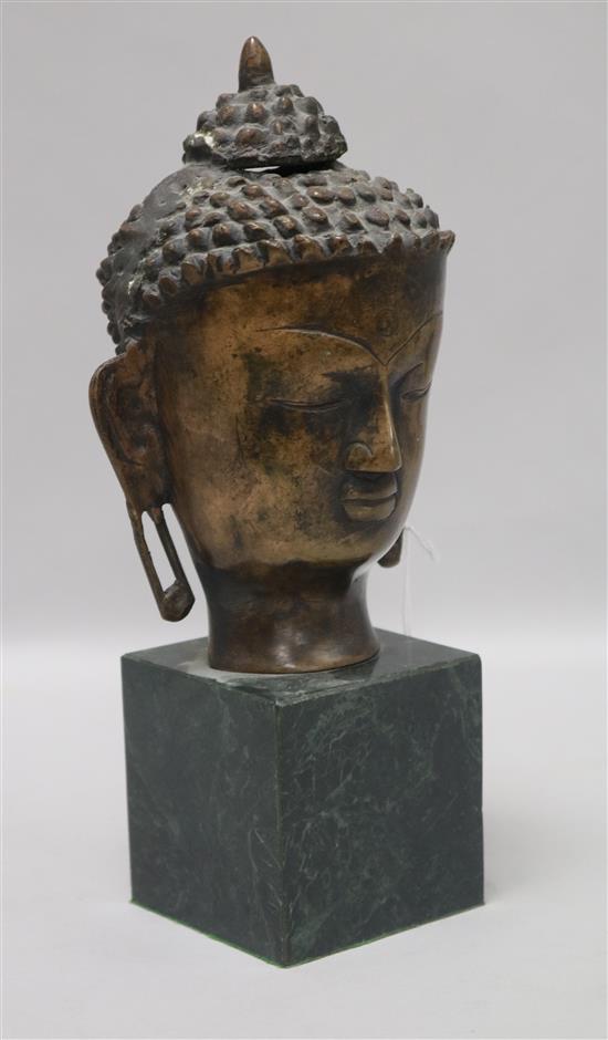 A bronze bust of a Buddha on stand height 26cm